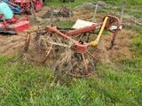 un tracteur qui se trouve dans l'herbe, avec une charrue attelée