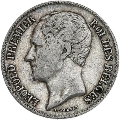 a silver coin with a woman ' s head on it