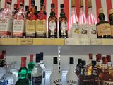 bottles of alcohol are lined up on a shelf in a store