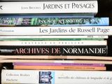 many books in a box that are stacked on top of each other