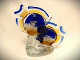 a glass vase with a blue and yellow flower inside of it