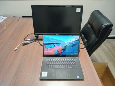 a laptop computer sitting on a desk with a laptop on it