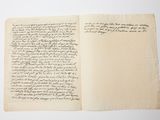an open book with writing on it sitting on top of a table