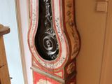 a grandfather clock that is in the corner of the room