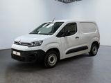 the white van is parked in a large white room