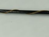 a stick with a feather on it on a white surface
