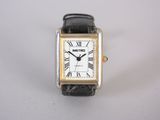a close up of a wrist watch with roman numerals