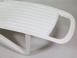 a white toilet seat that is on a white table