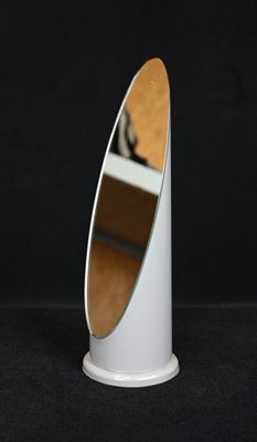un miroir blanc posé sur un pied, sur fond noir