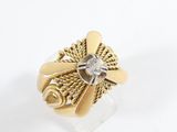 a close up of a gold ring with a diamond in the center