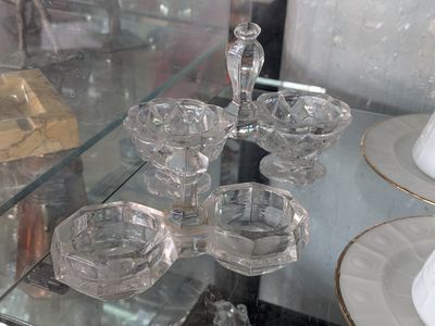 a glass display case with a number of glass dishes