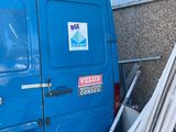 a blue van that is parked in front of a building