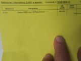 someone is holding a yellow piece of paper with information on it