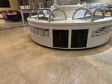 a large white counter in the middle of a large room
