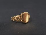 a close up of a gold ring on a black surface