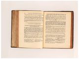 an open book on a white surface with a white background