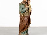 a statue of jesus holding a child in his arms