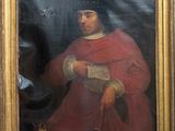 portrait of a man in a red cloak holding a book in a gold frame