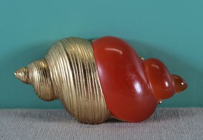 a red and gold shell with a red shell on it