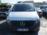 a white van parked in a parking lot with other cars