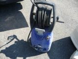 a blue pressurer that is on the ground next to a car