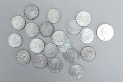 a pile of silver coins on a gray surface