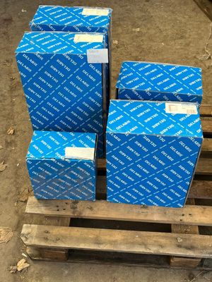 four blue boxes on a pallet in a warehouse