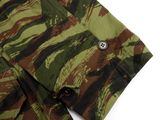 a close up of a camouflage shirt with buttons on the chest