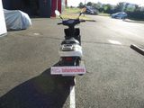 a scooter that is parked on the side of the road