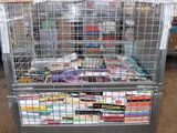 a metal cart with many books on it in a warehouse