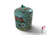 a blue vase with flowers and birds painted on it