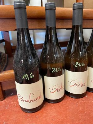 four bottles of wine are lined up on a table