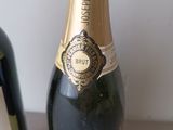 a bottle of champagne and a bottle of wine on a table