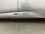 a picture of a silver car with a sticker on it