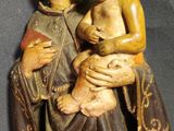 statue of a woman holding a baby and a child in her arms