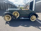 an image of an antique car parked in a parking lot