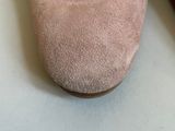 pair of women ' s sued shoes on a white surface with a white background