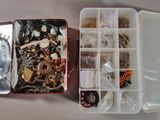 two boxes of jewelry sitting on a table next to each other
