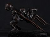 bronze statue of a boy with a hammer and a dog on a black background