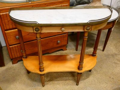 a table with a marble top on it in a room