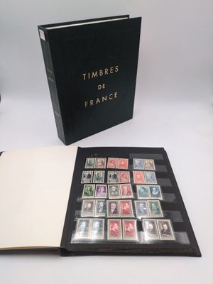 an open book with stamps on it sitting on top of a table