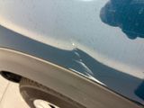 a close up of a car ' s front bumper with scratches on it