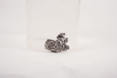 a small piece of silver on a white surface