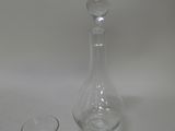 a glass and a decanter sitting on a table