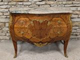 an antique chest of drawers with a marble top on a stand