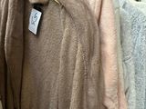 many coats hanging on a rack in a store