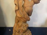 statue of a woman holding a flower in her hand
