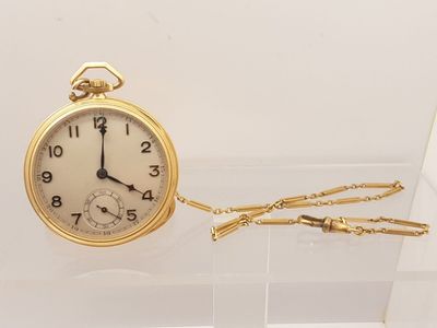 a gold pocket watch with a chain hanging from it
