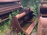 a rusted out machine sitting in the grass