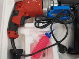 a drill and other tools in a box on a table